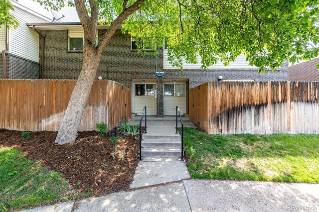 8023 Wolff St Unit C, Westminster, CO 80031 - view of front of home featuring brick siding and a fenced backyard