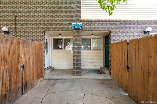 8023 Wolff St Unit C, Westminster, CO 80031 - view of property exterior with fence and brick siding