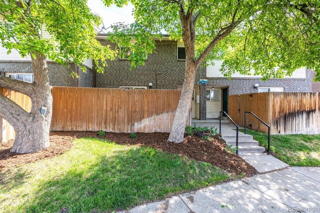 8023 Wolff St Unit C, Westminster, CO 80031 - view of front of house with fence and brick siding