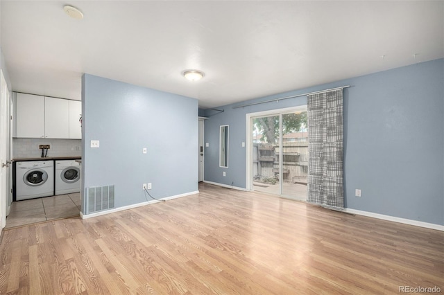 8023 Wolff St Unit C, Westminster, CO 80031 - unfurnished living room featuring light wood-style floors, independent washer and dryer, and baseboards