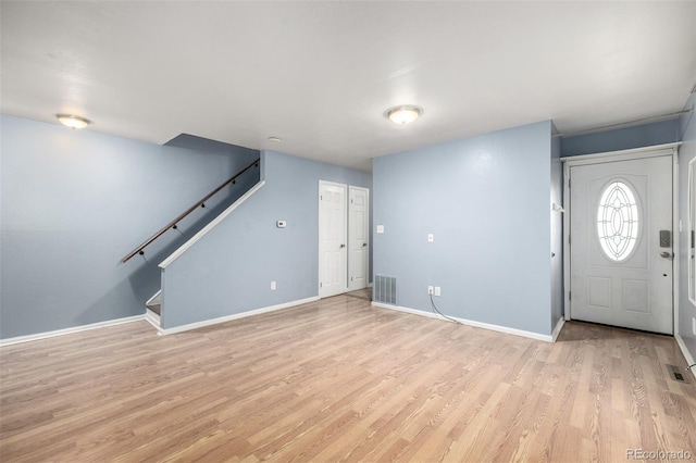 8023 Wolff St Unit C, Westminster, CO 80031 - foyer featuring stairway, light wood-style floors, and baseboards