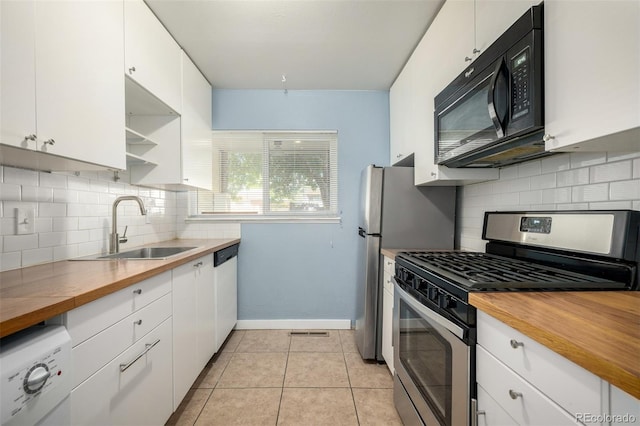 8023 Wolff St Unit C, Westminster, CO 80031 - kitchen with gas stove, black microwave, a sink, and wood counters
