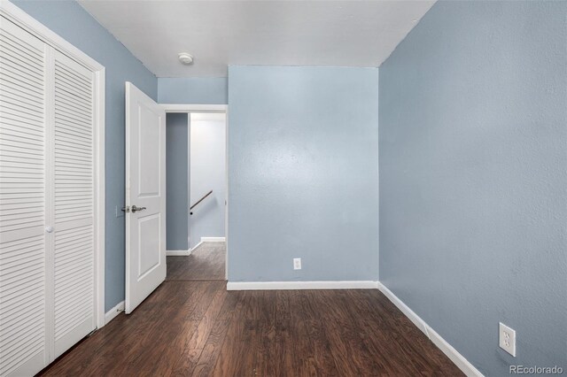 8023 Wolff St Unit C, Westminster, CO 80031 - unfurnished bedroom featuring baseboards, a closet, and wood finished floors