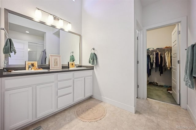 11059 E 25th Dr, Aurora, CO 80010 - full bath with double vanity, an enclosed shower, and a spacious closet