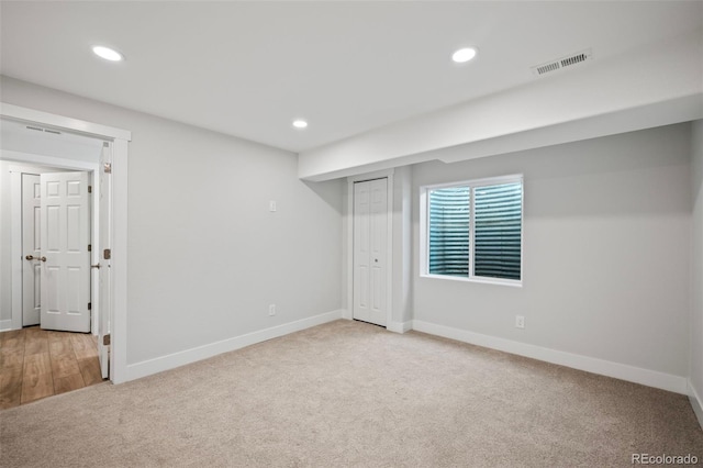 unfurnished bedroom with a closet and light colored carpet