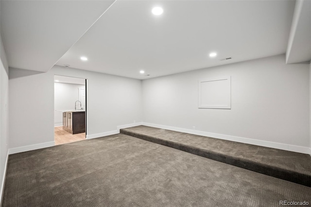 basement with carpet and sink