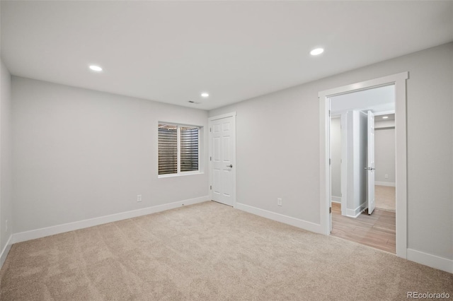 spare room featuring light colored carpet