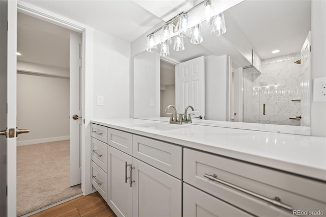 bathroom with vanity, hardwood / wood-style flooring, and a shower with shower door