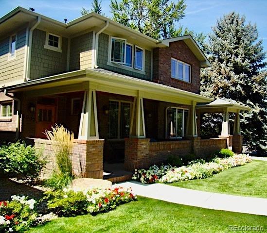 1907 S Columbine St, Denver, CO 80210 - view of front of home with covered porch, a front yard, and brick siding