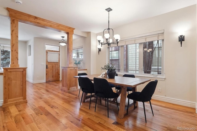 1907 S Columbine St, Denver, CO 80210 - dining space with decorative columns, a chandelier, and light wood-type flooring