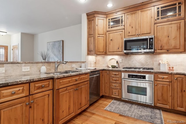 1907 S Columbine St, Denver, CO 80210 - kitchen with stainless steel appliances, light stone countertops, tasteful backsplash, light wood finished floors, and recessed lighting