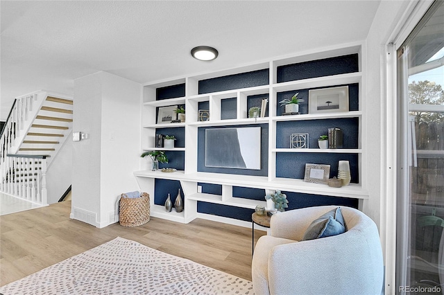 living area with hardwood / wood-style floors