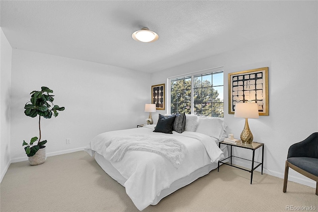 carpeted bedroom featuring a textured ceiling