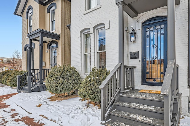 view of snow covered property entrance