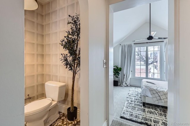 bathroom with lofted ceiling, ceiling fan, and toilet