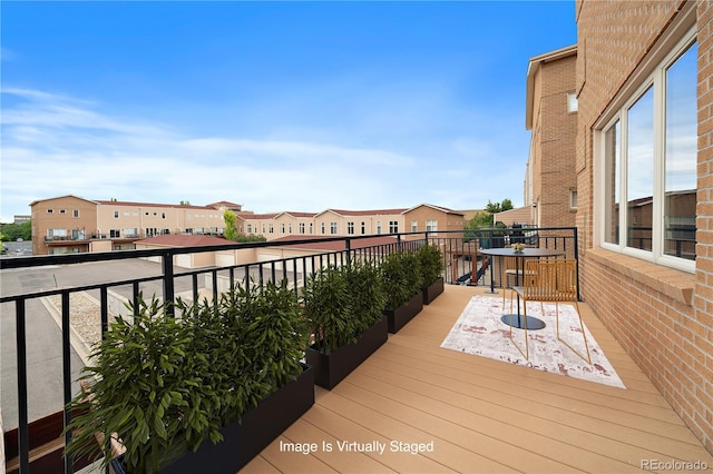 wooden deck featuring a residential view