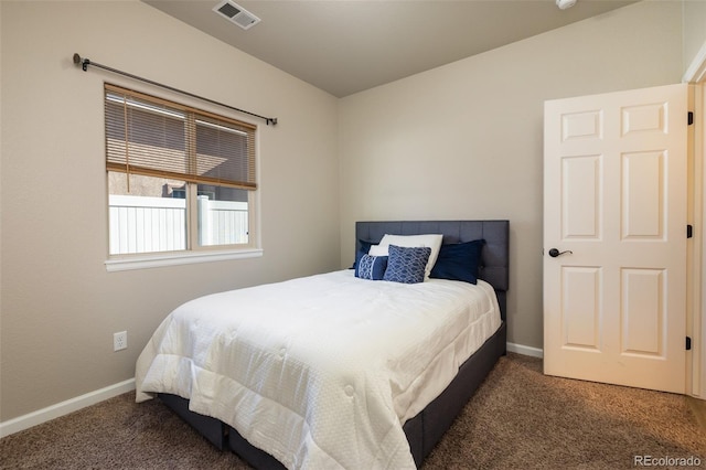 bedroom featuring dark colored carpet