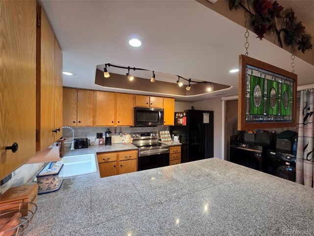 604 S Xenon Ct, Lakewood, CO 80228 - kitchen with stainless steel electric stove, black refrigerator with ice dispenser, rail lighting, a raised ceiling, and recessed lighting