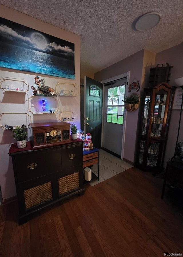 604 S Xenon Ct, Lakewood, CO 80228 - entryway featuring wood finished floors and a textured ceiling