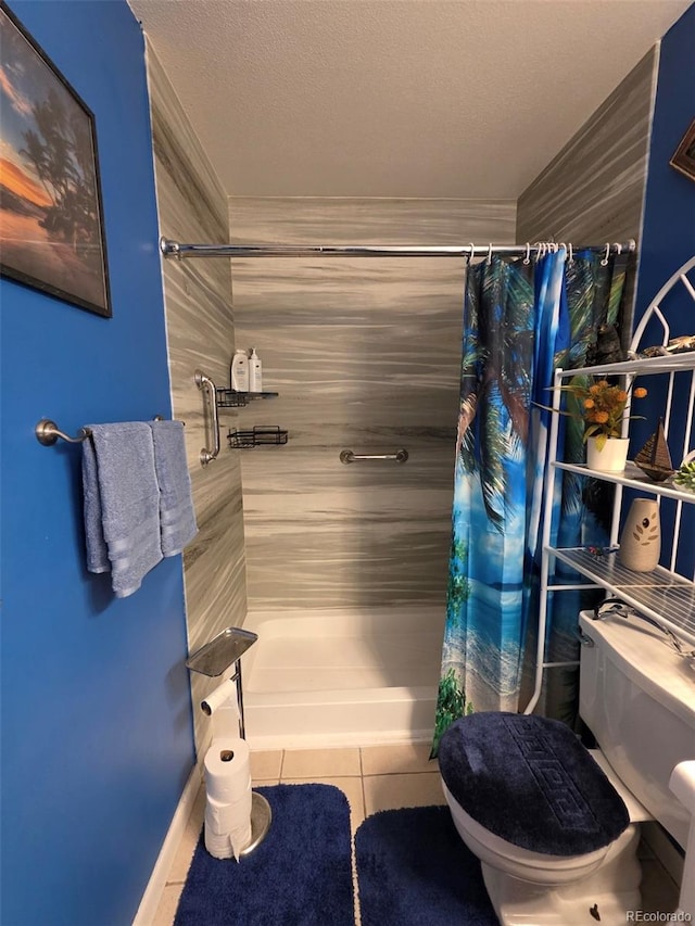 604 S Xenon Ct, Lakewood, CO 80228 - bathroom featuring a shower with shower curtain, tile patterned floors, and a textured ceiling