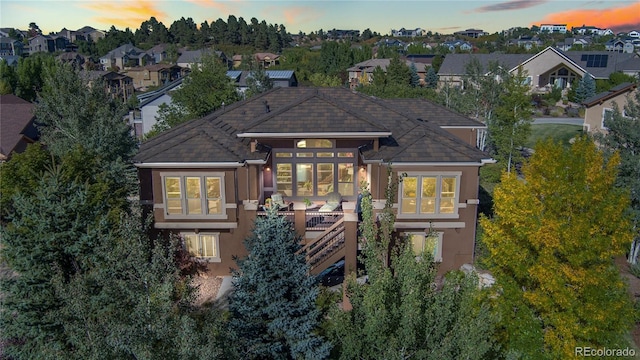 12477 Creekhurst Dr, Colorado Springs, CO 80921 - back of property featuring stucco siding, a residential view, stairway, and a wooden deck