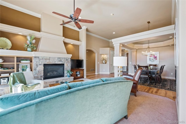 12477 Creekhurst Dr, Colorado Springs, CO 80921 - living room featuring ornamental molding, baseboards, ceiling fan, arched walkways, and a fireplace
