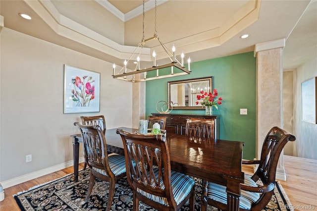 12477 Creekhurst Dr, Colorado Springs, CO 80921 - dining area featuring wood finished floors, a chandelier, recessed lighting, crown molding, and a raised ceiling