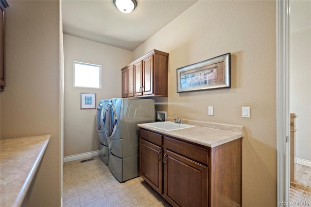 12477 Creekhurst Dr, Colorado Springs, CO 80921 - washroom featuring cabinet space, washer and dryer, and baseboards