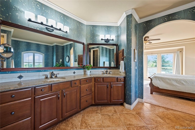 12477 Creekhurst Dr, Colorado Springs, CO 80921 - ensuite bathroom with wallpapered walls, healthy amount of natural light, crown molding, a ceiling fan, and double vanity