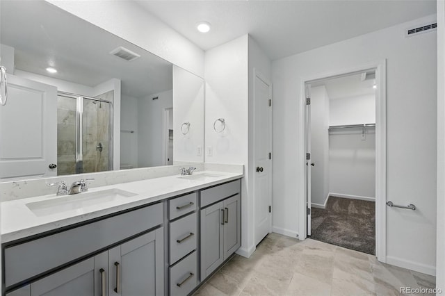 17115 W 91st Ln, Arvada, CO 80007 - full bath featuring a shower stall, double vanity, a walk in closet, baseboards, and recessed lighting