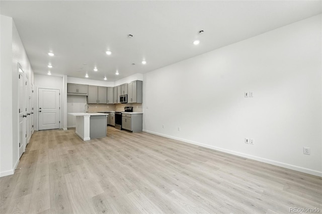 17115 W 91st Ln, Arvada, CO 80007 - kitchen with gray cabinetry, stainless steel appliances, recessed lighting, open floor plan, and a sink