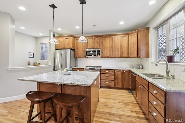 3240 Spruce St, Denver, CO 80238 - kitchen with appliances with stainless steel finishes, light wood-type flooring, brown cabinets, decorative backsplash, and a kitchen bar