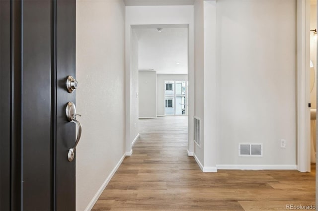 corridor with light hardwood / wood-style flooring