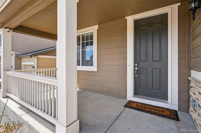 12623 Canoe St, Firestone, CO 80504 - view of exterior entry featuring covered porch and a surveillance system