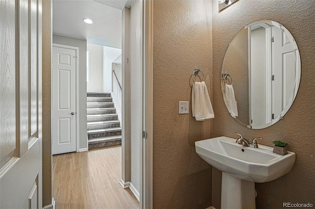 12623 Canoe St, Firestone, CO 80504 - bathroom with wood finished floors and a textured wall