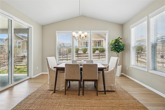 12623 Canoe St, Firestone, CO 80504 - dining room with a chandelier, light wood-style flooring, plenty of natural light, and lofted ceiling