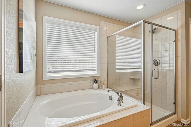 12623 Canoe St, Firestone, CO 80504 - bathroom featuring a bath, a stall shower, and recessed lighting
