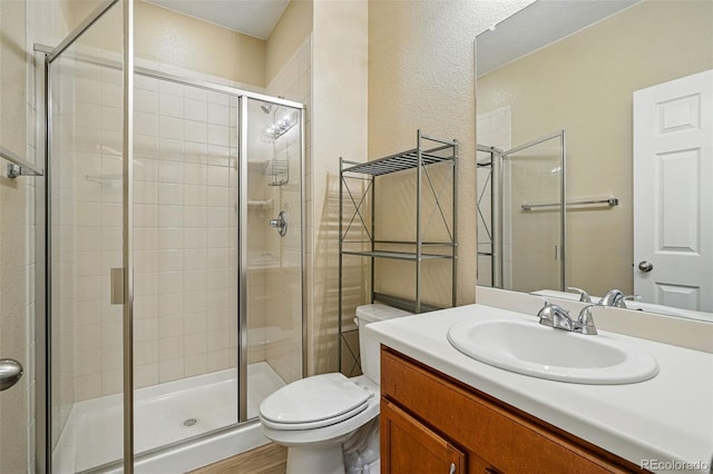 12623 Canoe St, Firestone, CO 80504 - bathroom with vanity, a shower stall, and wood finished floors