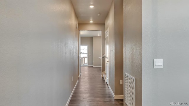 hallway featuring dark hardwood / wood-style flooring