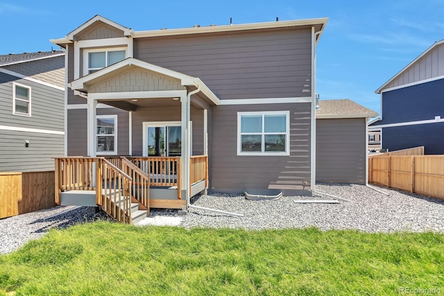 back of property with a lawn and a wooden deck