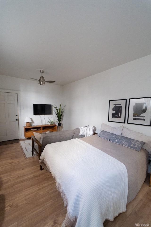 bedroom with wood finished floors and a ceiling fan