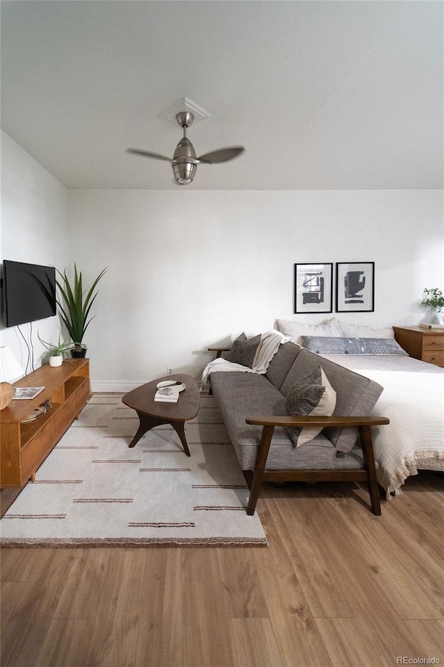 living room featuring wood finished floors and a ceiling fan