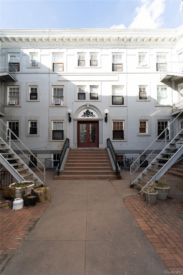view of front facade featuring french doors and stairway