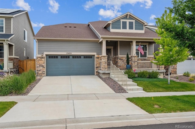 17409 Springfield Dr, Parker, CO 80134 - craftsman-style house featuring a garage, concrete driveway, stone siding, a porch, and roof with shingles