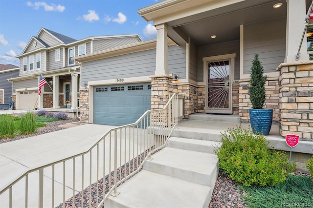 17409 Springfield Dr, Parker, CO 80134 - view of exterior entry with stone siding, concrete driveway, and an attached garage