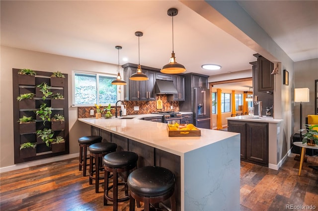 3125 Xenon St, Wheat Ridge, CO 80215 - kitchen with high end appliances, exhaust hood, a peninsula, and a sink