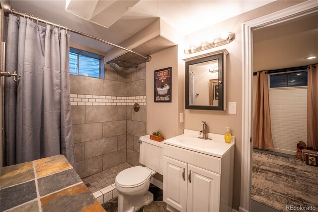 3125 Xenon St, Wheat Ridge, CO 80215 - bathroom with a tile shower, vanity, and toilet