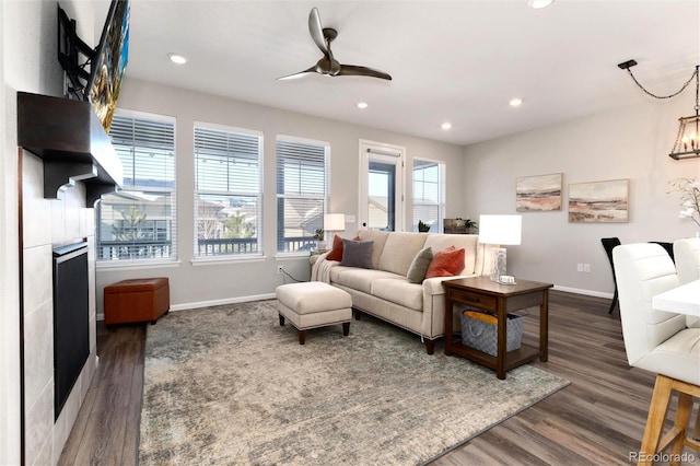 living room with ceiling fan and dark hardwood / wood-style flooring