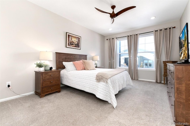 bedroom with ceiling fan and light colored carpet