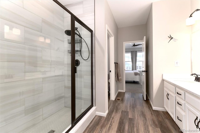 bathroom with an enclosed shower, vanity, and hardwood / wood-style flooring